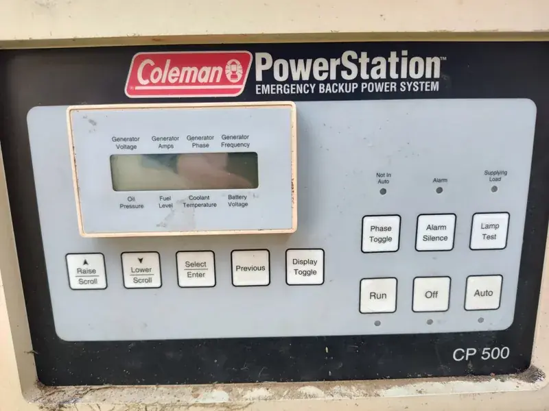 Coleman PowerStation CP 500 control panel with a display labeled for voltage, amps, oil pressure, fuel level, coolant temperature and battery voltage, and Run, Off and Auto buttons.