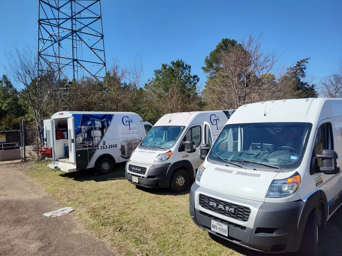 Three GenTechAPS service vans and an equipment trailer lined up and ready